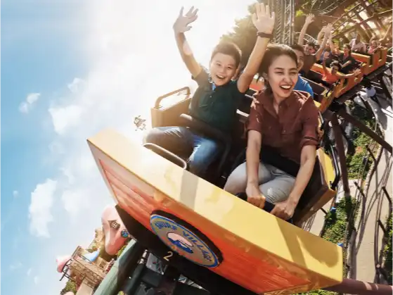 Image of two young adults taking a ride in a theme park in Dubai