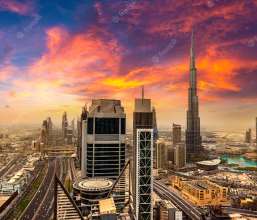 Aerial view of the city of Dubai, with the Burj Khalifa and other tall buildings in the background.