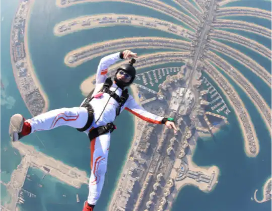 a skydiver over Palm Jumeirah in Dubai