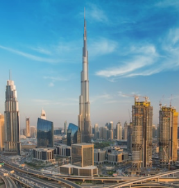Aerial view of the city of Dubai, with the Burj Khalifa and other tall buildings in the background.